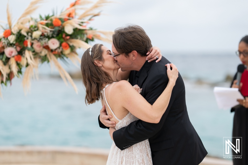 Couple shares a romantic kiss during their beautiful destination wedding at Sunscape Curacao beach resort