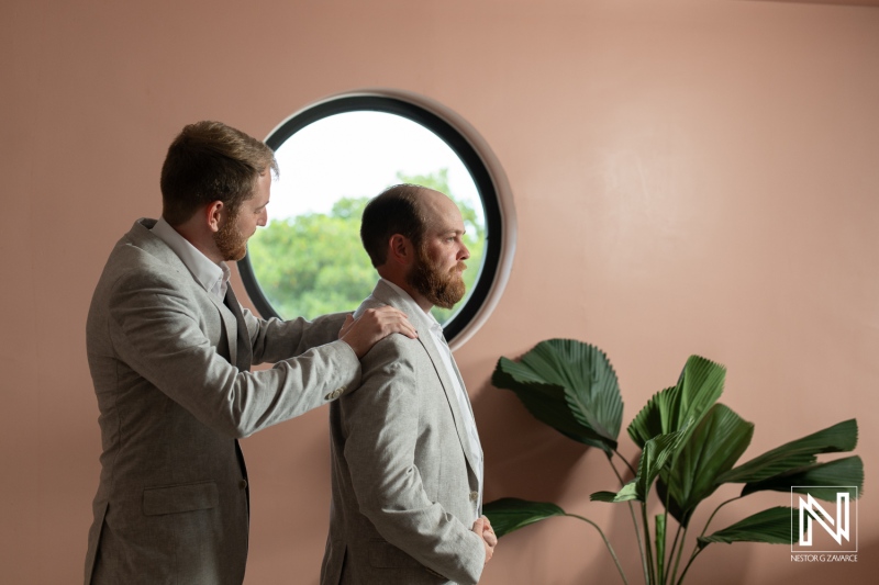 Groom receiving final preparations before a wedding ceremony at Mangrove Beach in Curacao