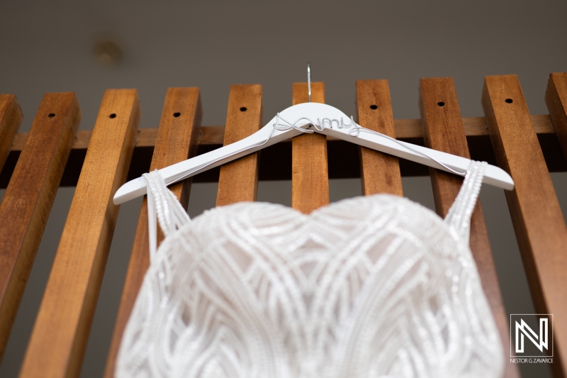 Exquisite wedding gown hanging at The Rif at Mangrove Beach in Curacao, showcasing intricate beadwork before the wedding ceremony