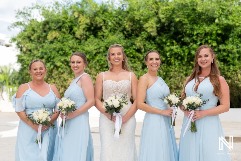 Wedding celebration at The Rif at Mangrove Beach Corendon in Curacao featuring a joyful bridal party with elegant flowers