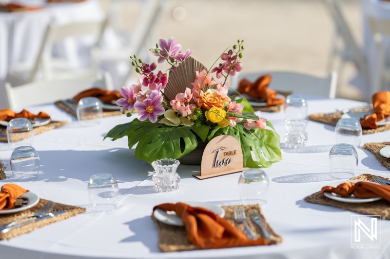 Elegant wedding table setting with vibrant floral centerpiece at Mangrove Beach in Curacao