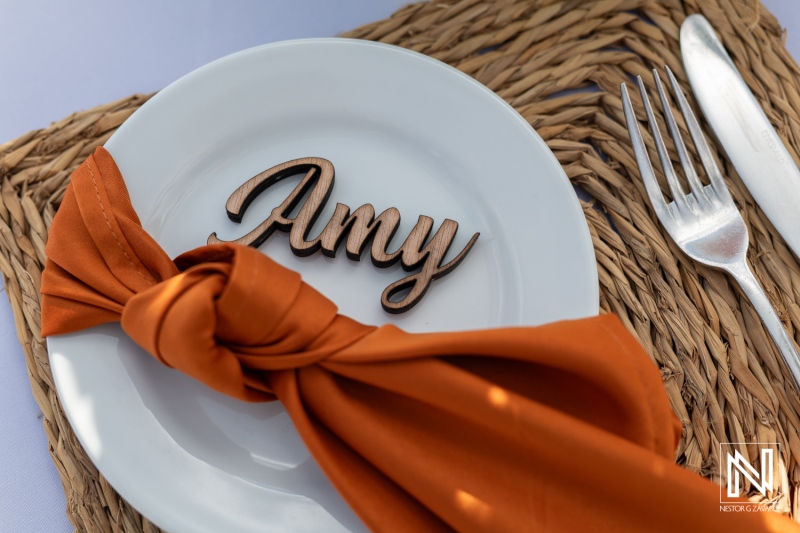 Elegant wedding table setting featuring a personalized nameplate at The Rif at Mangrove Beach Corendon in Curacao during a beautiful afternoon