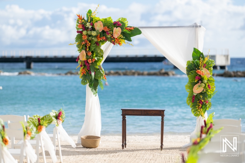 Stunning wedding setup at Mangrove Beach in Curacao with floral arrangements and ocean view under clear skies