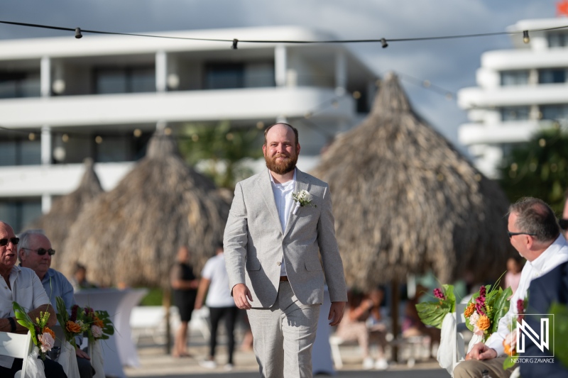 Wedding ceremony creates a memorable moment at the Rif at Mangrove Beach Corendon in Curacao with a groom walking down the aisle