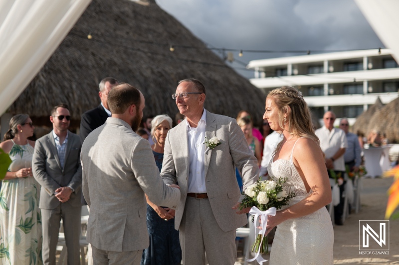 Ceremony of love at The Rif at Mangrove Beach, Curacao, capturing a couple exchanging vows under a beautiful sky