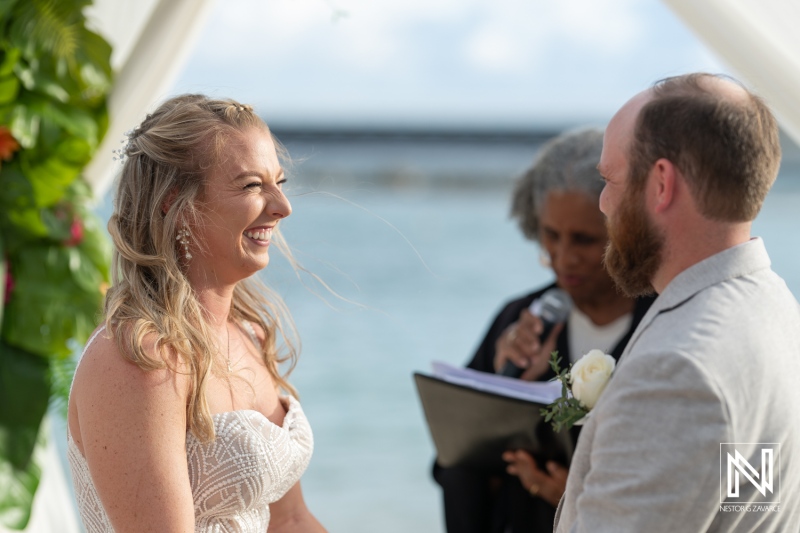 Wedding ceremony celebration at Mangrove Beach in Curacao with joyful couple and officiant by the sea