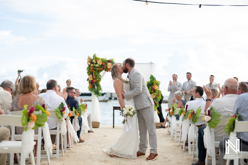 Celebrating love during a beach wedding ceremony at Mangrove Beach in Curacao with elegant decor and joyful guests