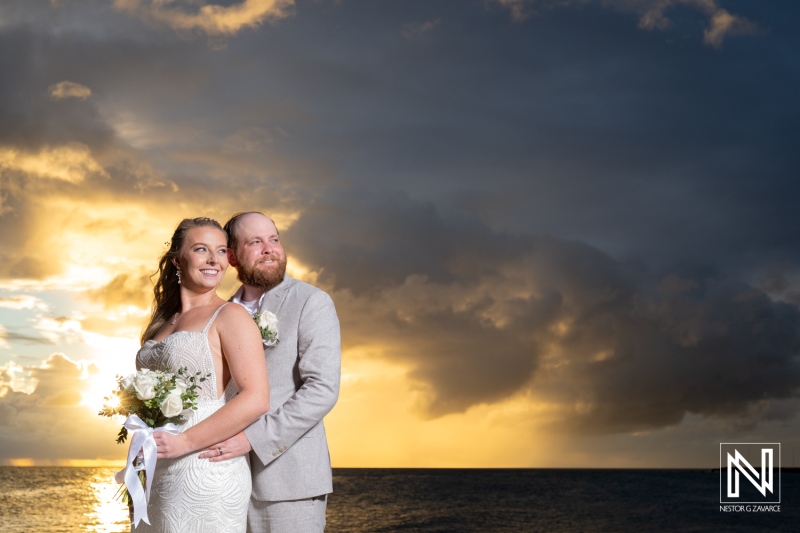 Couple shares a romantic moment at sunset during their wedding at Rif at Mangrove Beach in Curacao