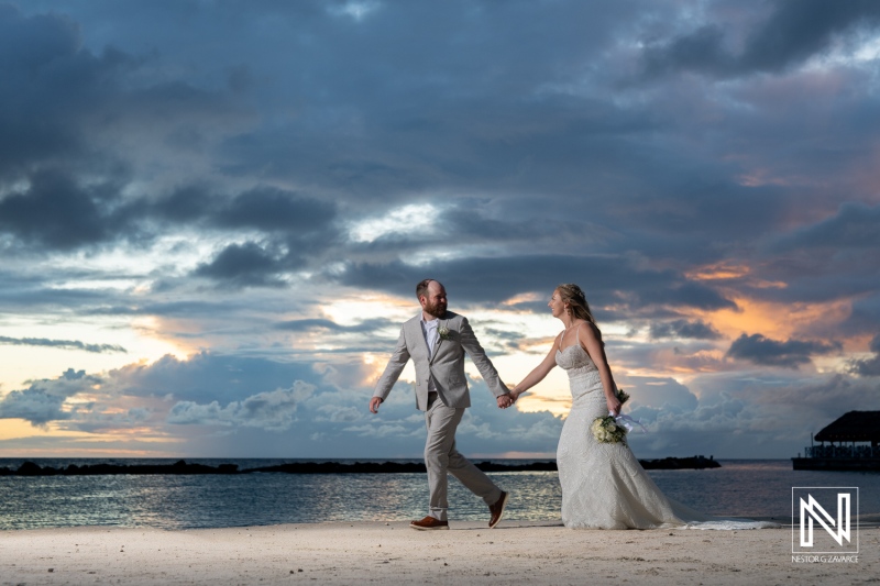 Couple celebrates their wedding on a picturesque beach in Curacao at The Rif at Mangrove Beach Corendon during sunset