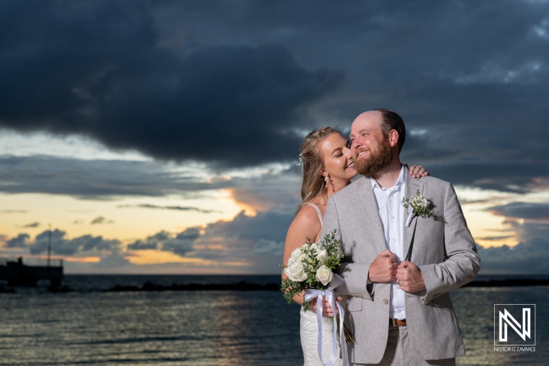 Wedding celebration in Curacao on Mangrove Beach at sunset with a couple sharing a joyful moment