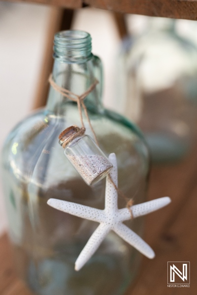 Beautiful wedding decor featuring a glass bottle and starfish at Mangrove Beach Corendon in Curacao creating a romantic ambiance for the special day