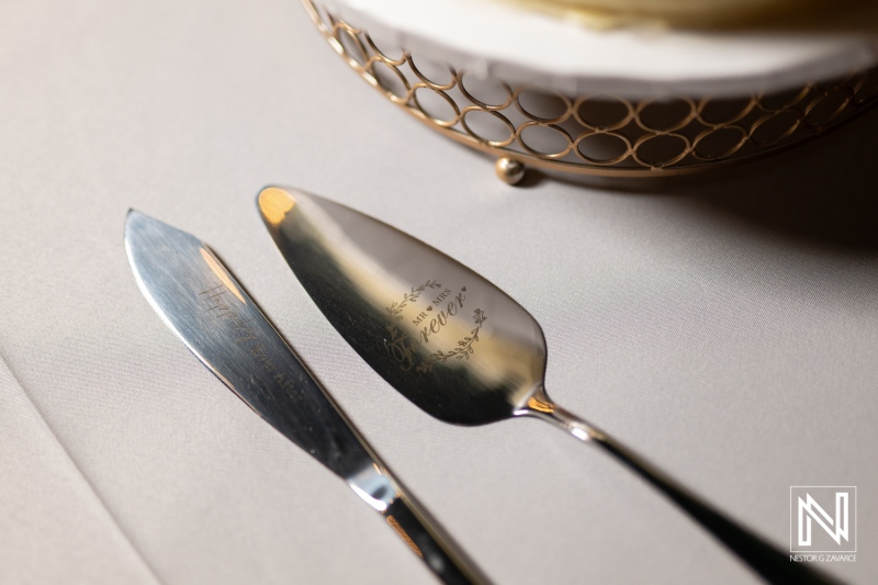 Elegant wedding details at Rif at Mangrove Beach Corendon in Curacao showcase personalized cake serving utensils during a beautiful celebration under the Caribbean sun
