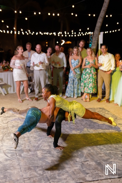 Dance performance highlights joy and celebration at Curacao wedding on the beach under twinkling lights