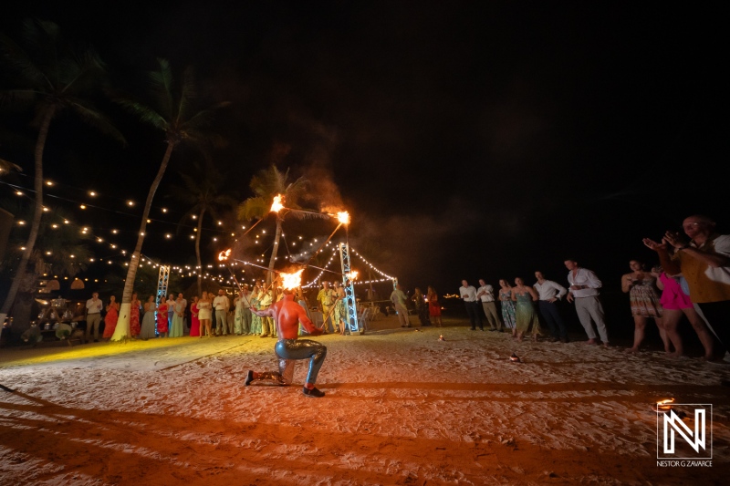 Celebration of love with a fire performer at a beautiful wedding in Curacao's Mangrove Beach