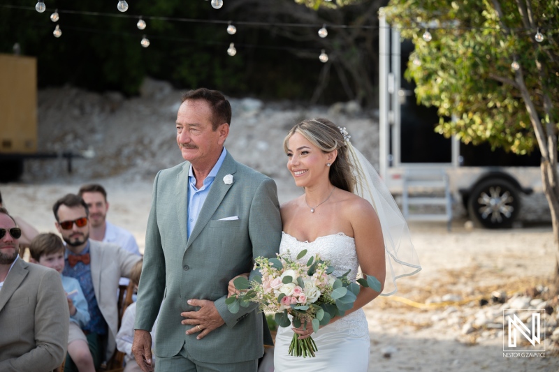 Couple walking down the aisle at a wedding in Playa Hunku in Curacao during a sunny day