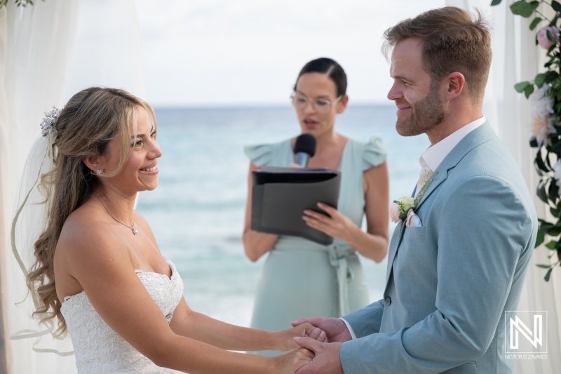 Wedding ceremony at Playa Hunku in Curacao by the sea with couple and officiant present