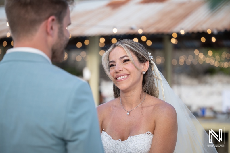 Wedding ceremony at Playa Hunku in Curacao with couple exchanging vows