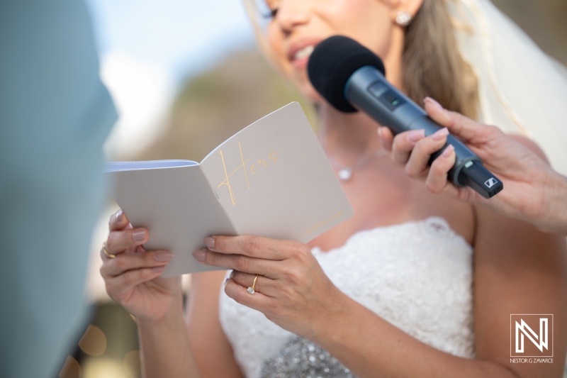 Ceremony at Playa Hunku with bride reading vows during wedding in Curacao