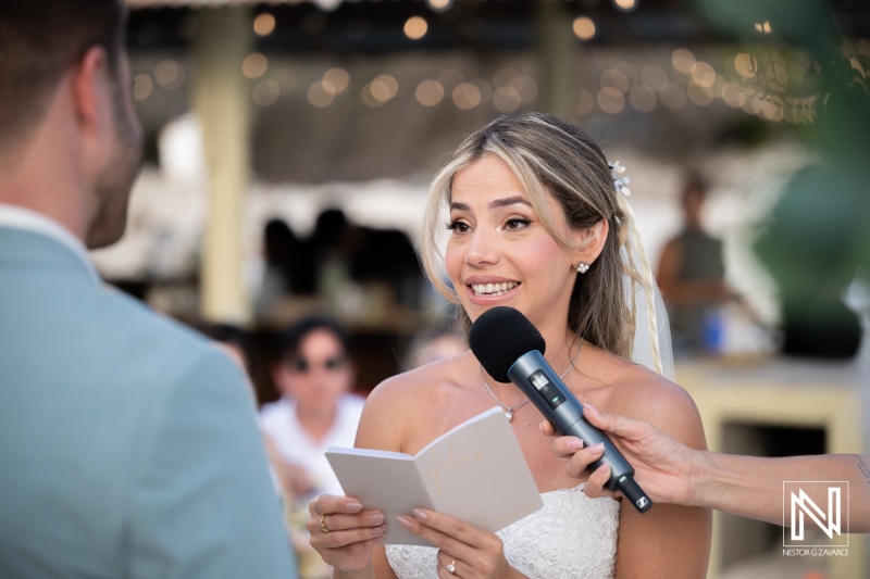 Wedding ceremony at Playa Hunku in Curacao with the bride reading vows
