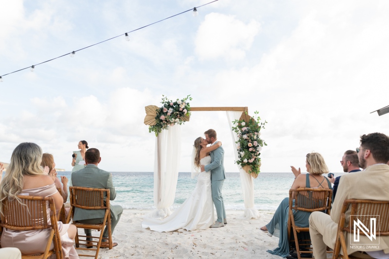 Wedding ceremony at Playa Hunku in Curacao showing couple sharing a kiss