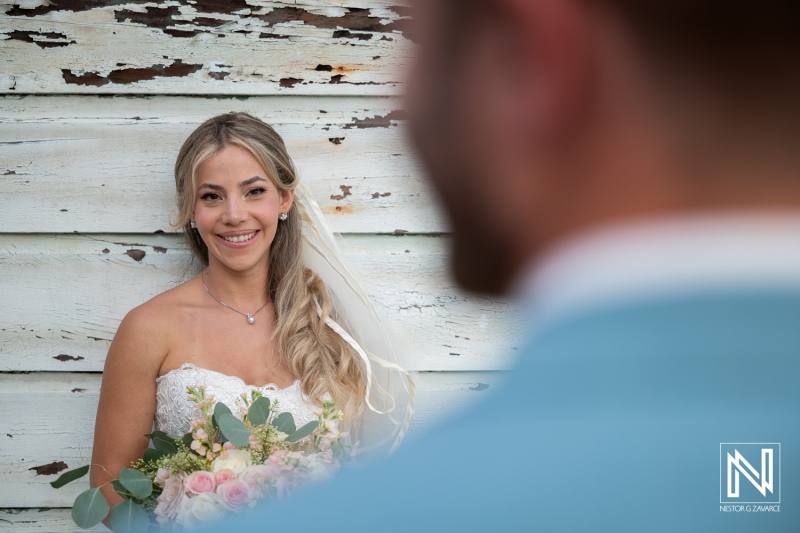 Wedding ceremony at Playa Hunku in Curacao with the bride smiling at the groom