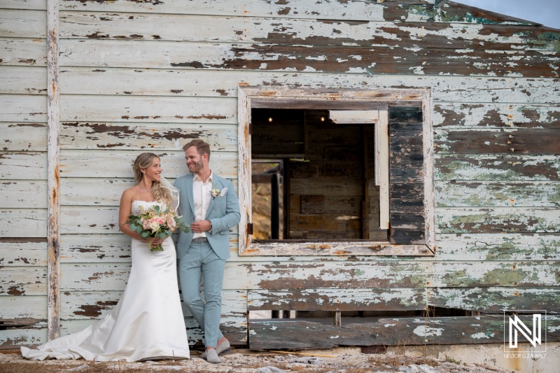 Couple stands together at their wedding outside Playa Hunku in Curacao during a bright day