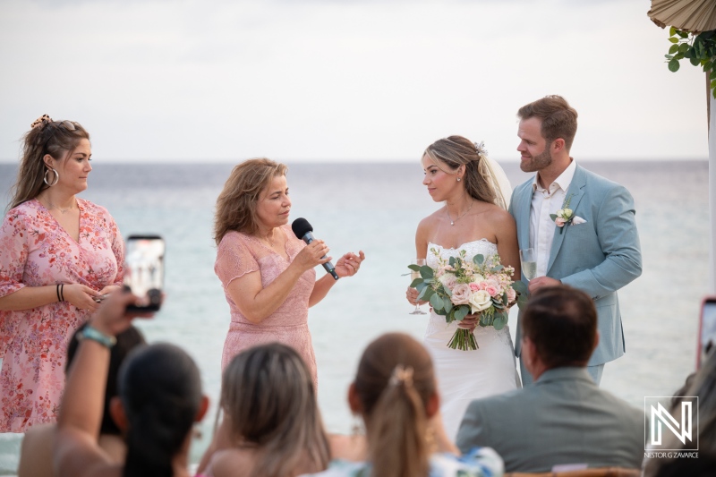 Wedding ceremony at Playa Hunku on Curacao with guests witnessing the vows