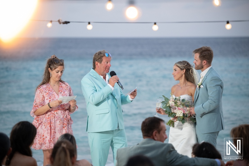Ceremony takes place at Playa Hunku during the wedding celebration in Curacao with friends and family present