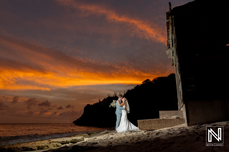 Couple shares a moment during their wedding at Playa Hunku in Curacao at sunset