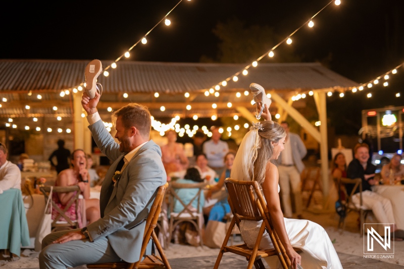 Couple celebrates at their wedding in Playa Hunku with guests enjoying the party at night