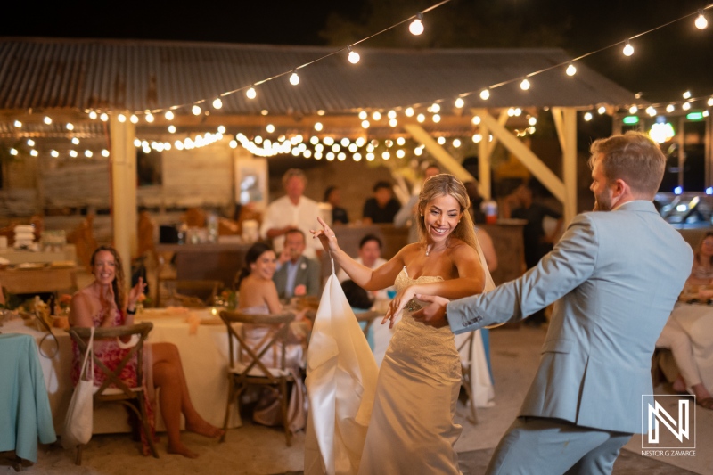 Couple dances together at a wedding celebration on the beach at Playa Hunku in Curacao during the night