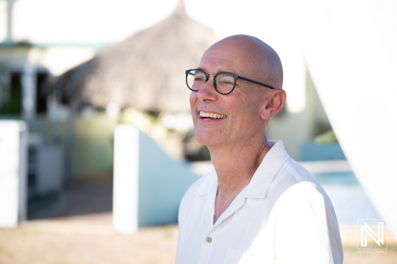 Wedding ceremony taking place at a tropical location in Westpunt Curacao with smiling guests enjoying the moment
