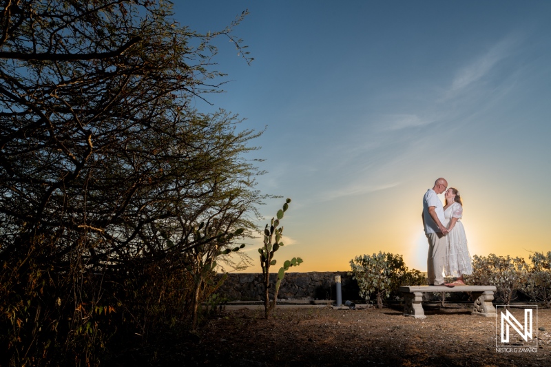 Couple stands together during wedding ceremony in Westpunt Curacao at sunset with natural surroundings
