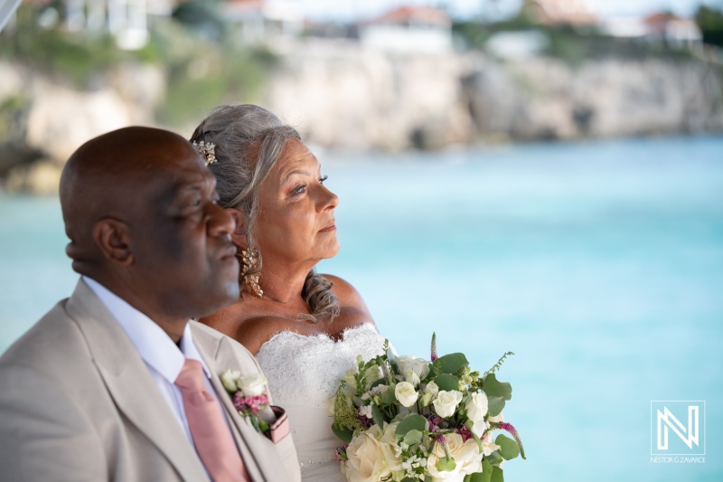Wedding ceremony at Karakter in Curacao takes place by the water on a sunny day