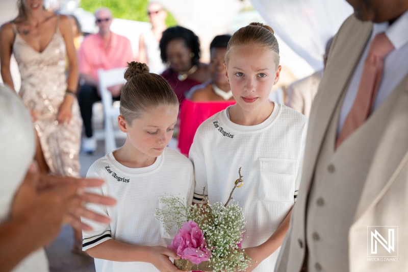 Wedding ceremony at Karakter in Curacao with flower girls and guests attending