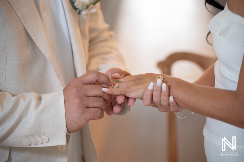Couple exchanges wedding rings during ceremony at Avila Beach Hotel in Curacao