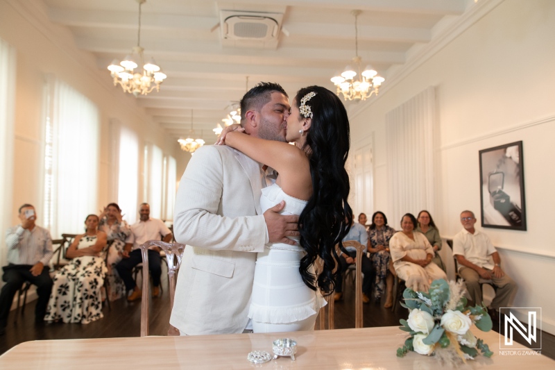 Wedding ceremony at Avila Beach Hotel in Curacao with couple sharing a kiss