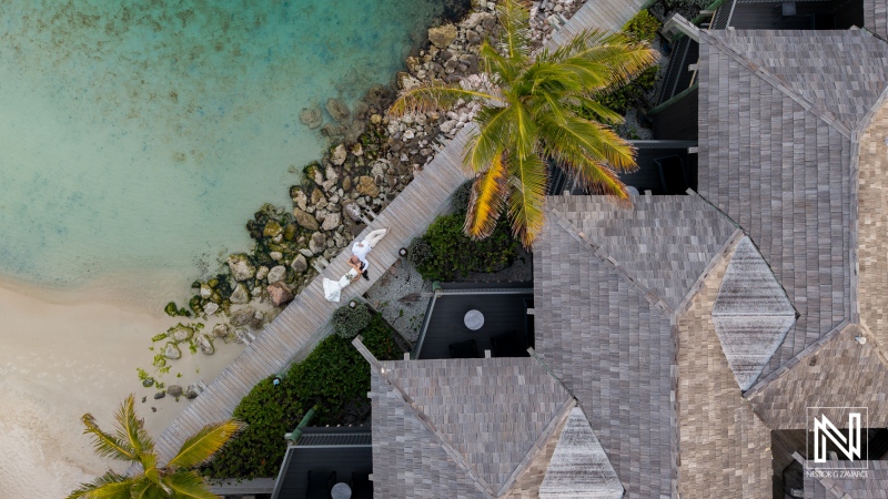 Wedding ceremony at Avila Beach Hotel in Curacao with guests gathered near the water