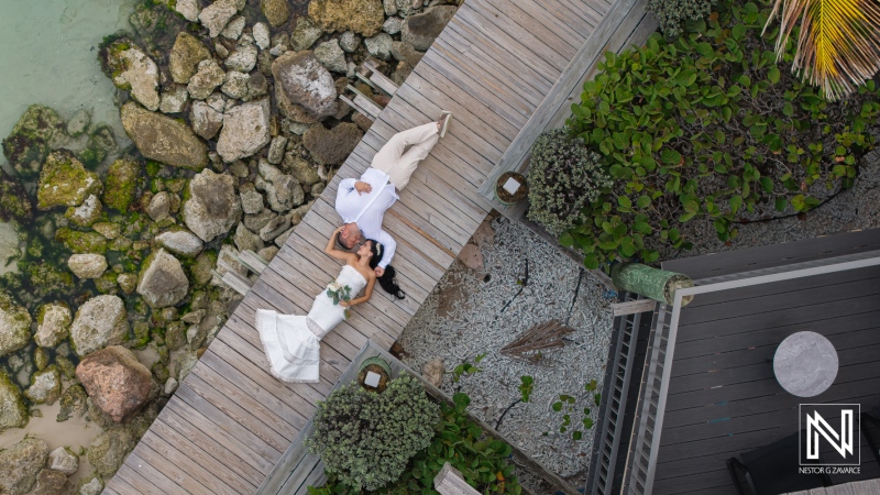 Wedding ceremony at Avila Beach Hotel on Curacao with bride and groom near the water