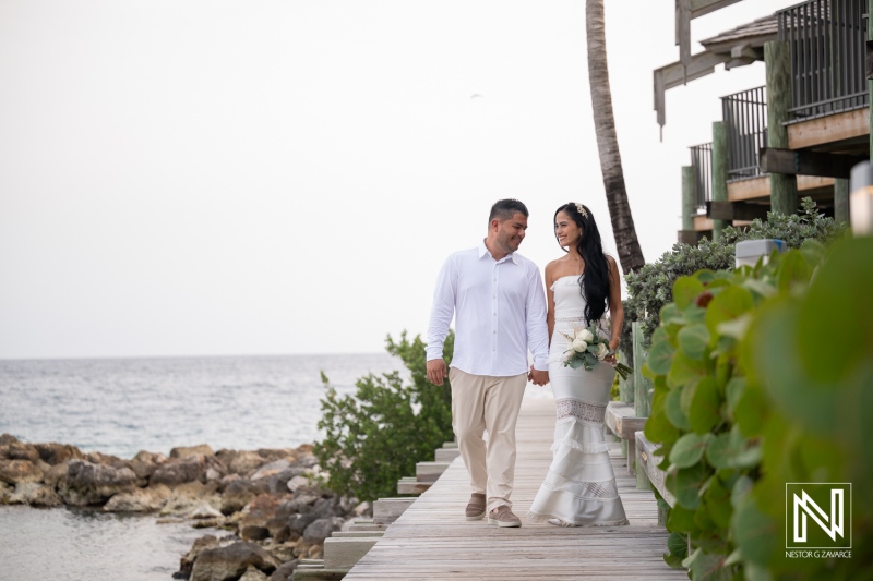 Couple walks hand in hand at Avila Beach Hotel during a wedding in Curacao