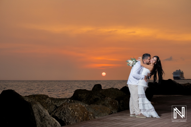 Couple enjoys moment at sunset during wedding ceremony at Avila Beach Hotel in Curacao