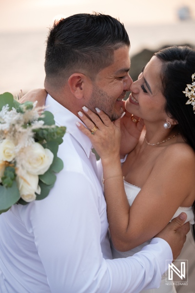 Couple shares a moment together during their wedding at Avila Beach Hotel in Curacao as the sun sets on the beach