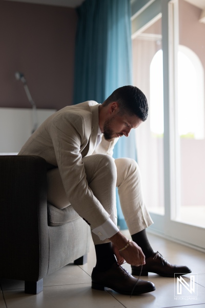 Groom gets ready for his wedding at Karakter on the beautiful island of Curacao in bright natural light