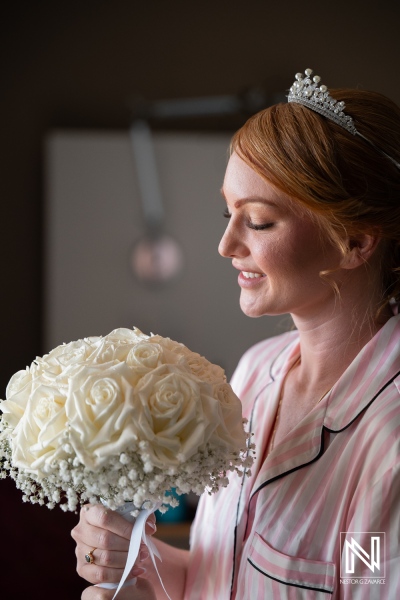 Beautiful bride preparing for her wedding at Karakter in Curacao, surrounded by elegant flowers and joyful moments