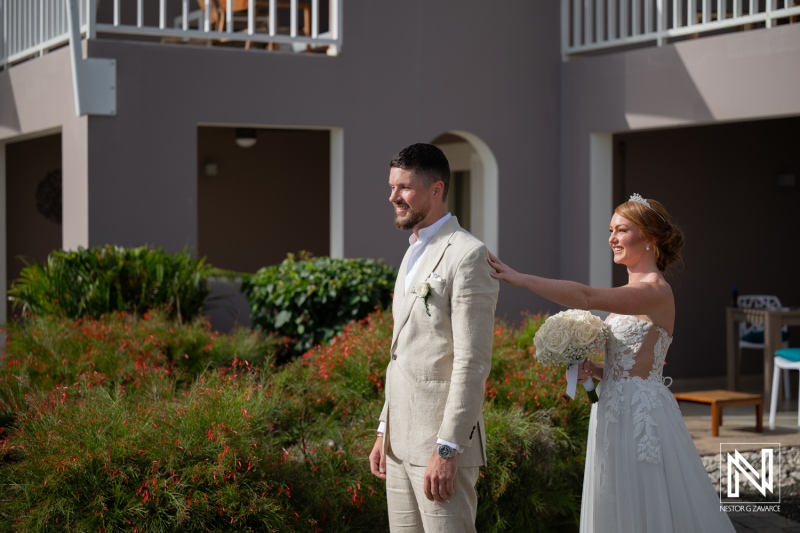 Beautiful wedding moment at Karakter in Curacao with bride surprising groom in a stunning outdoor setting
