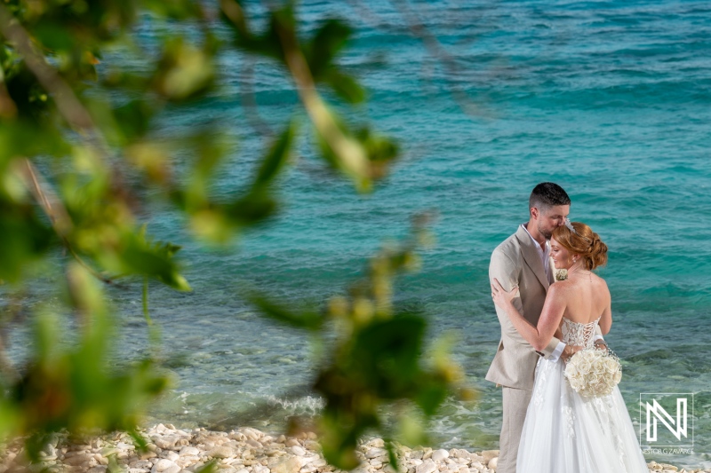 Dynamic wedding celebration at Karakter in Curacao with a couple embracing by the beach