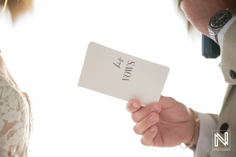 Couple exchanges heartfelt vows during their wedding ceremony at Karakter, Curacao, under a beautiful sunny sky