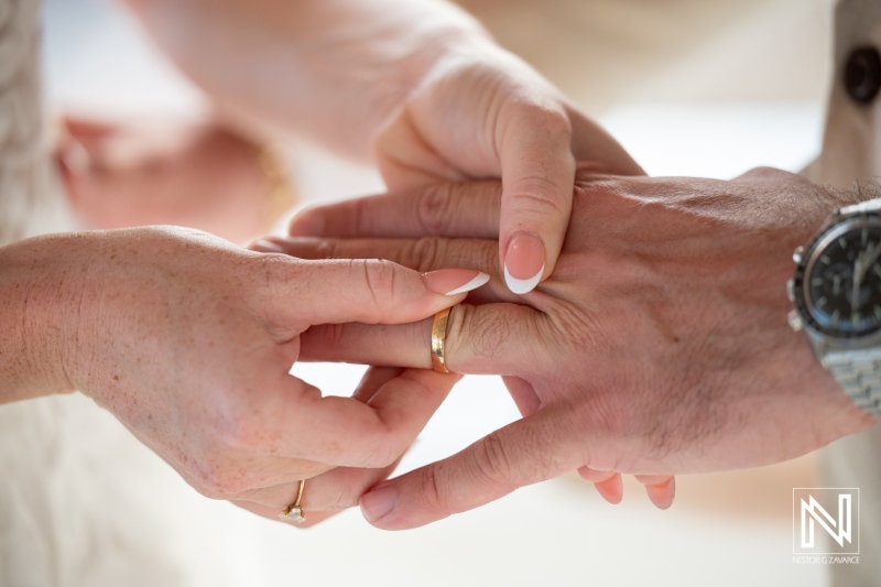 Couple exchanges wedding rings during a romantic ceremony at Karakter in Curacao by the beach