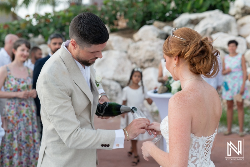 Couple celebrates their wedding at Karakter in Curacao with champagne under the sun