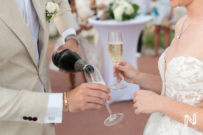 Couple celebrates their wedding with champagne at a beautiful venue in Curacao